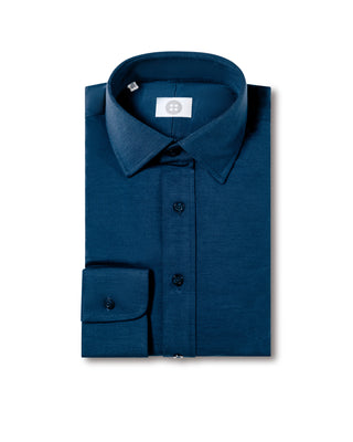 Folded blue shirt with a brand label on a white background